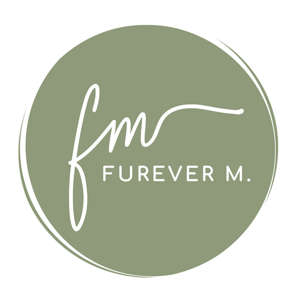 Furever M logo with script font over top of a sage green circular background.